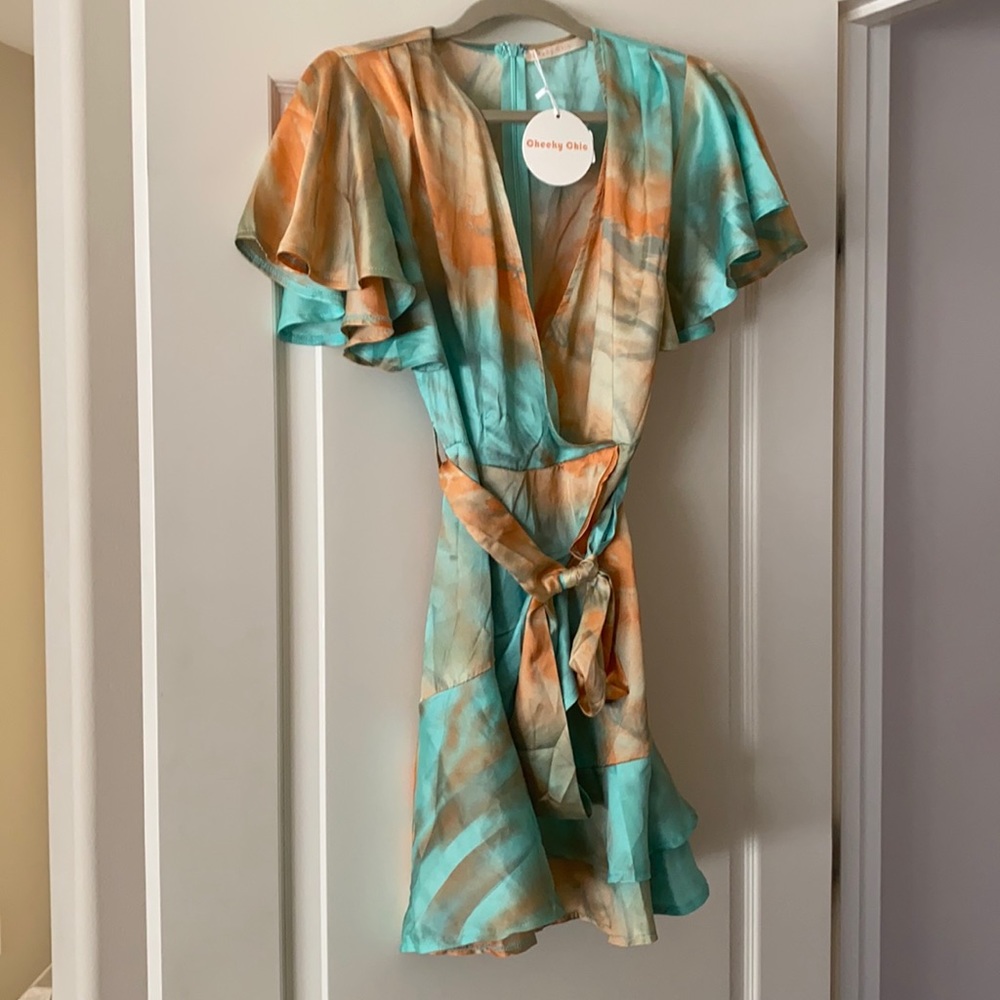 Tie dye flirty dress with ruffle sleeves and bottom.